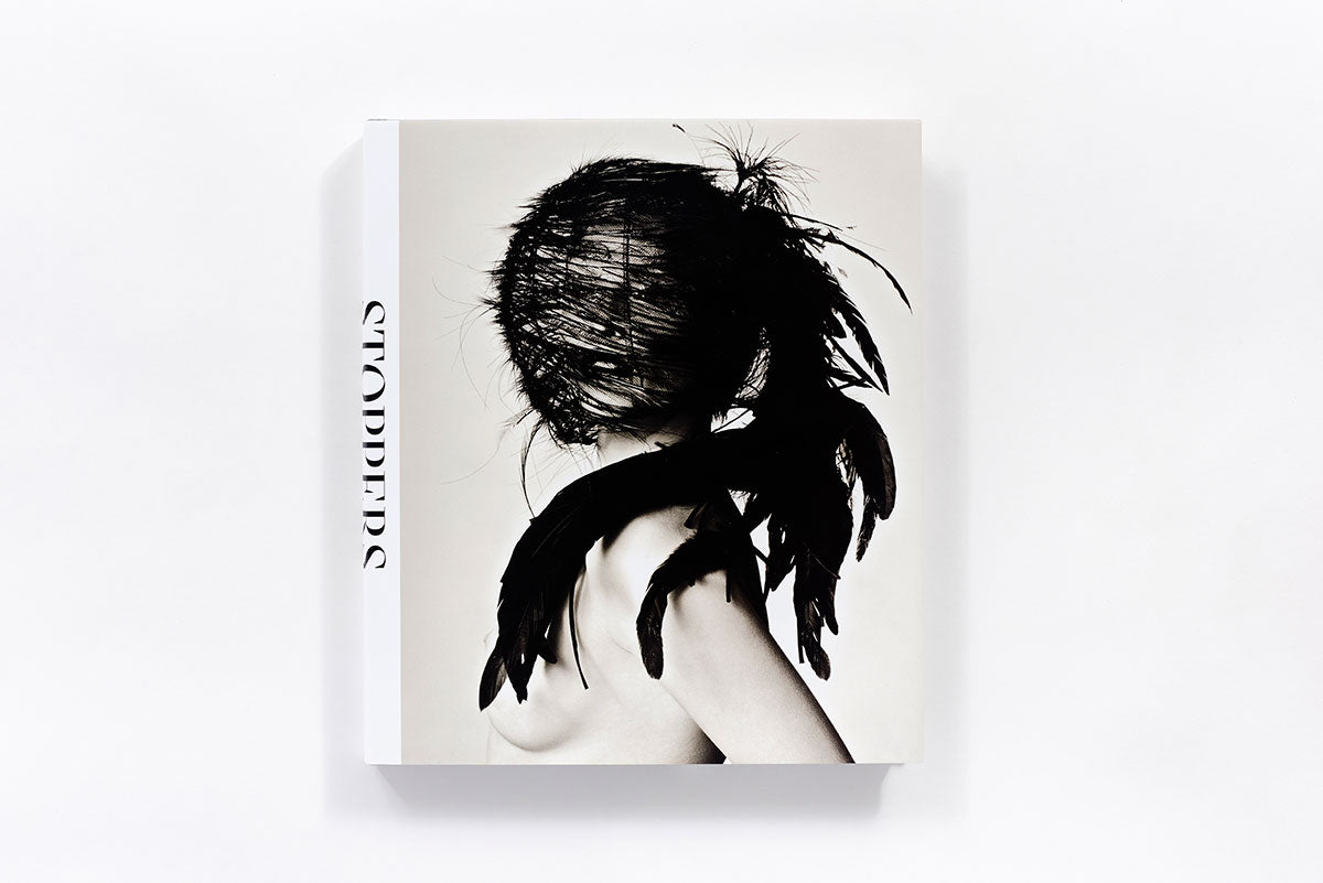 Book cover titled "Stoppers" with a black and white image of a person covered in dark feathers.