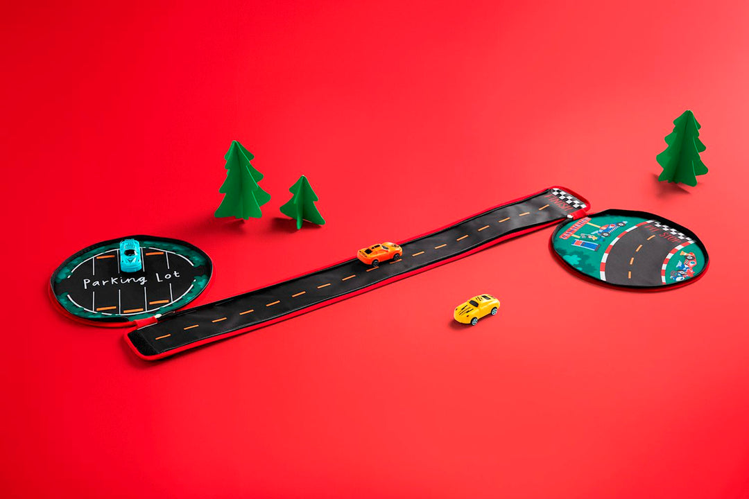 My Car Carrier Set featuring a fabric road, parking lot, pit stop, and three toy cars on red background.