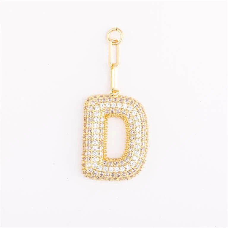 Heather-colored charm bag with gold plating, pave crystal accents, initial letter option, and one-inch extender.