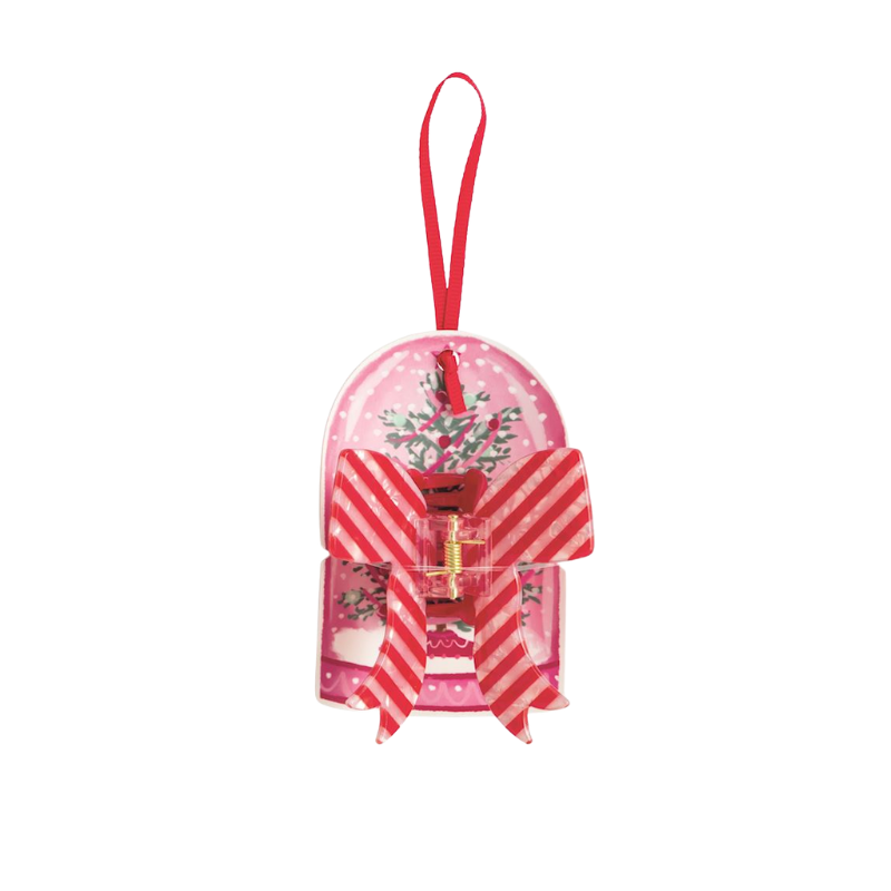 Red and white striped bow hair claw clip on a pink holiday ornament display card.