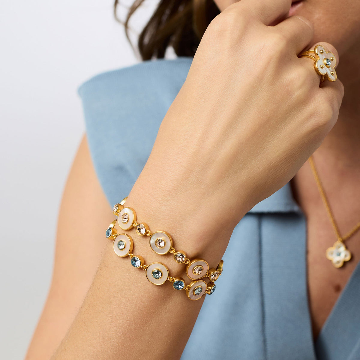 Adjustable Colette tennis bracelet featuring gold plating, cubic zirconia stones, and a mother-of-pearl center with a toggle clasp.
