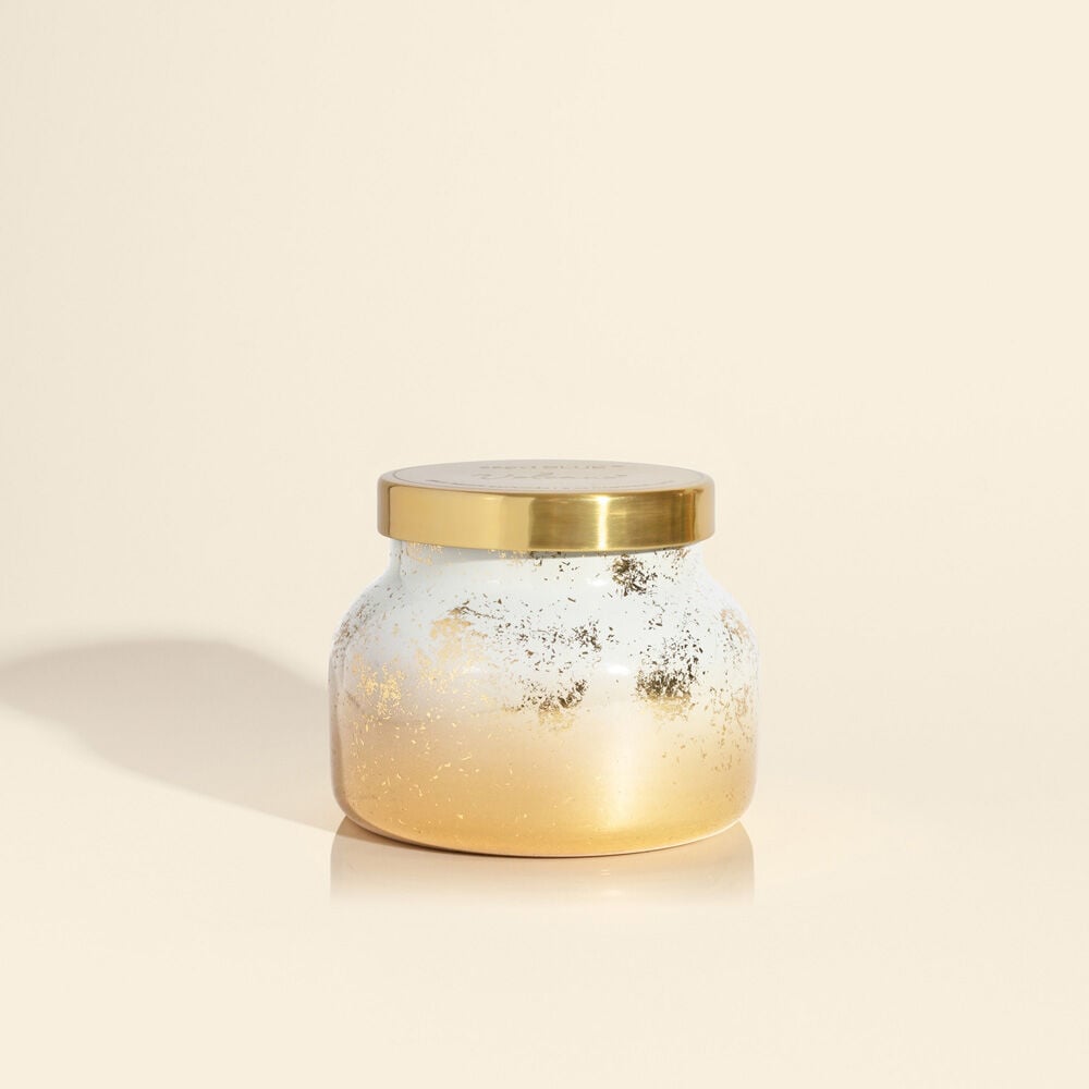 Volcano Glimmer Petite Jar candle in a small glass jar with a black wick.