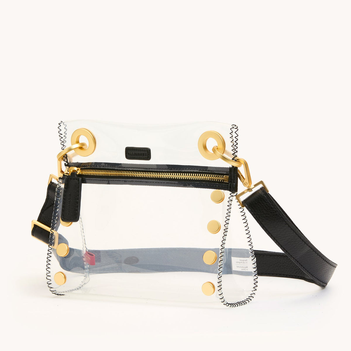 Clear Tony small bag with leather trim, adjustable strap, measuring 8 inches long.