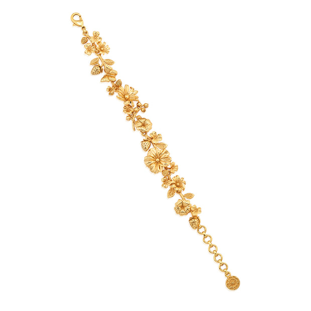 Gold-plated Meadow Bouquet link bracelet featuring intricate wildflower and butterfly charms.