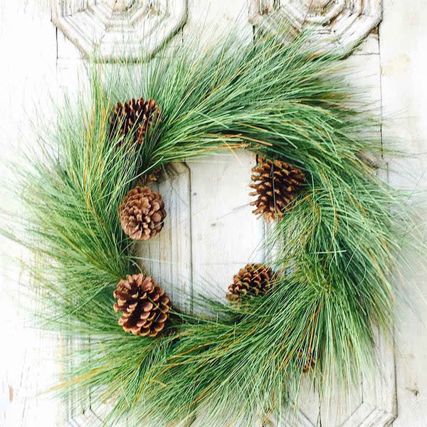 Round pine wreath with sugar cone accents in natural green tones