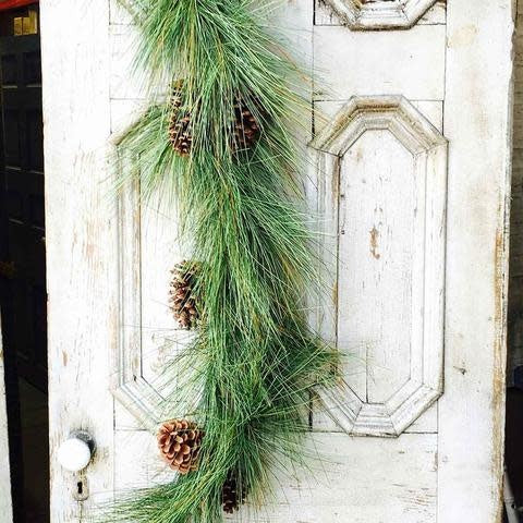 6-foot artificial garland with brown pine needles and green sugar cone accents.