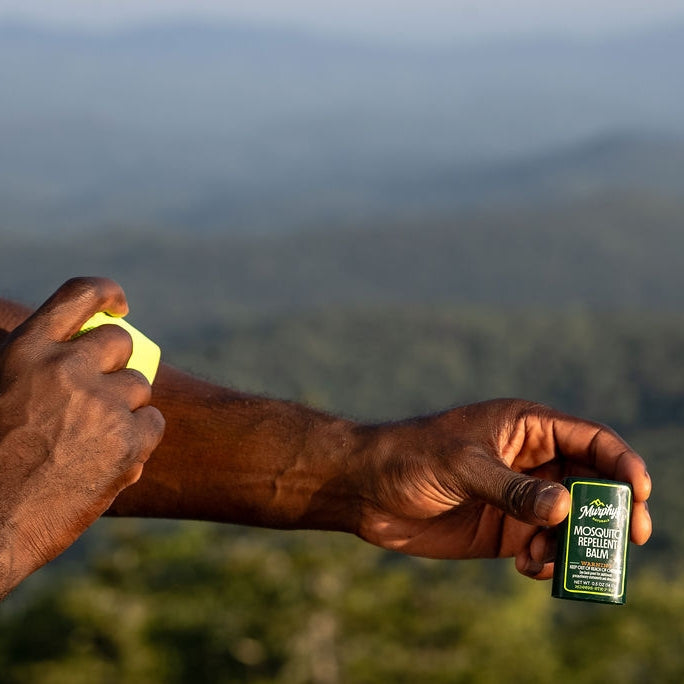 Two beige mosquito repellent balm sticks with natural ingredient labels.