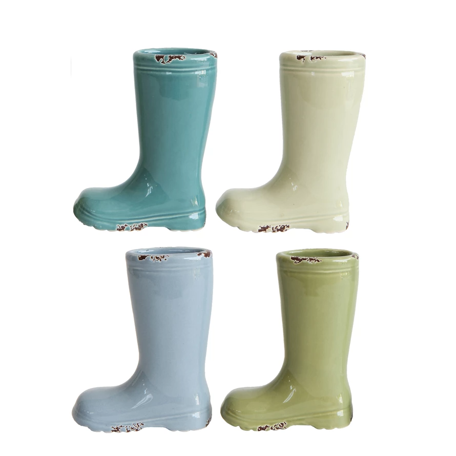 Distressed stoneware boot vase with a watertight finish in earthy tones.