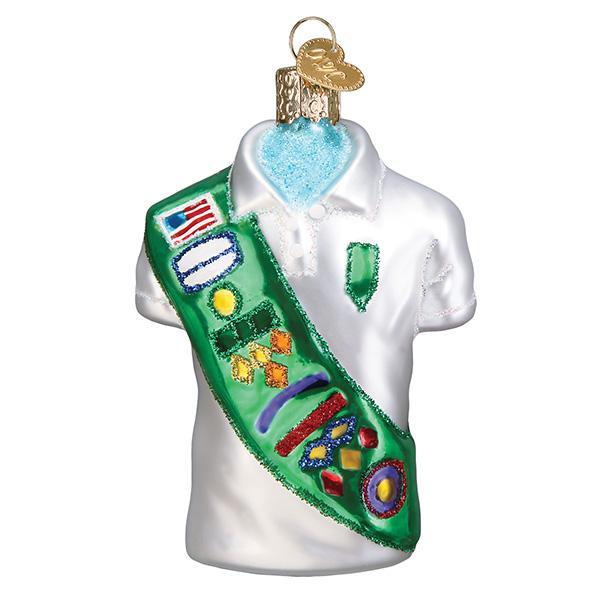 Glass Girl Scout uniform ornament featuring a white polo shirt and a green sash with colorful badges.