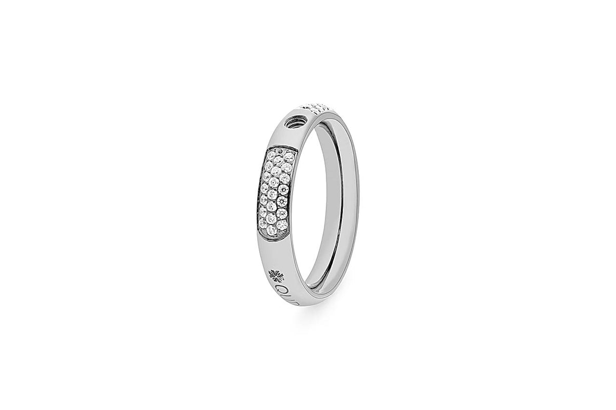 Silver ring with pave-set crystals on a curved band. Features a small screw detail and engraved logo.