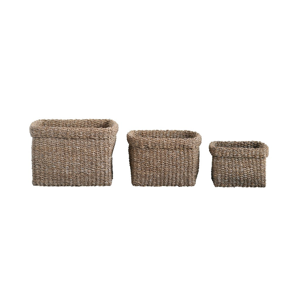 Woven seagrass basket with natural beige color, oval silhouette, and textured pattern.
