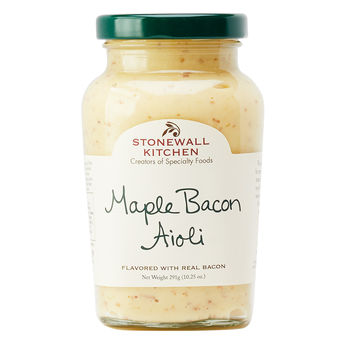 Jar of maple bacon aioli with visible speckled bits in creamy beige sauce