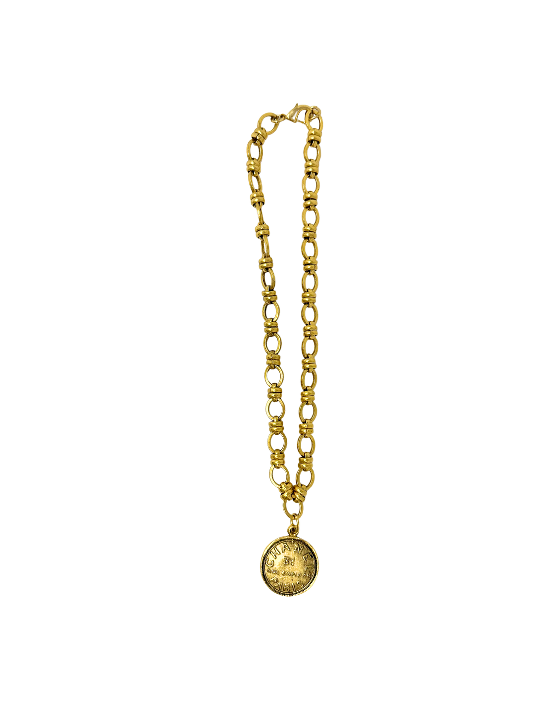 Gold Italian link necklace with a round coin pendant featuring engraved designer text.