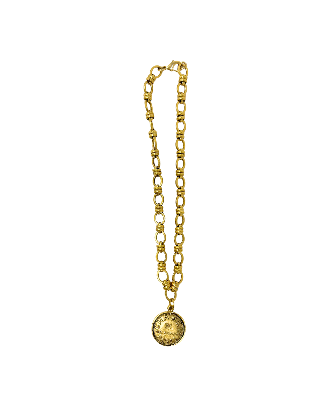 Gold Italian link necklace with a round coin pendant featuring engraved designer text.