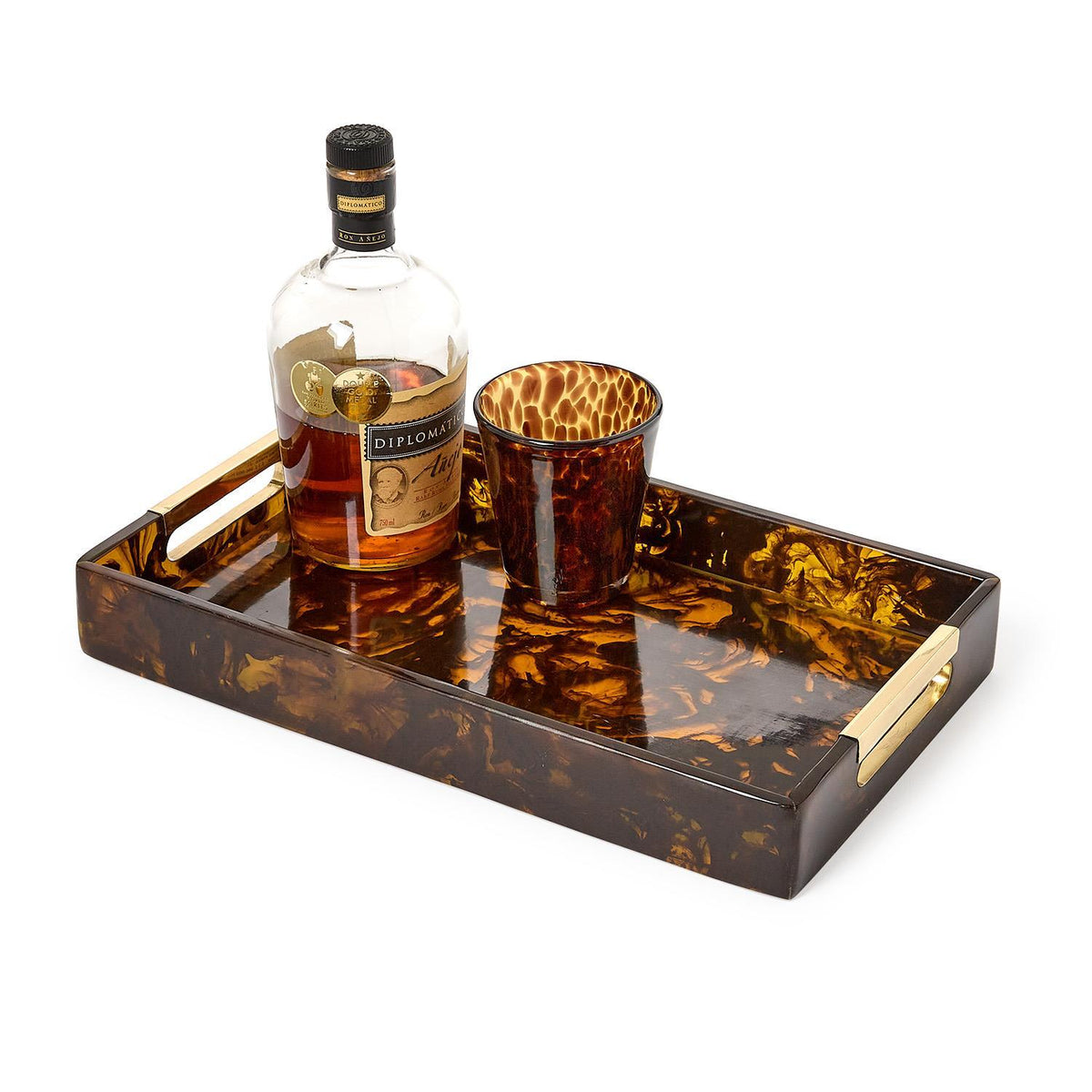 Tortoise swirl rectangle serving tray with gold handles, holding a bottle and a matching glass.