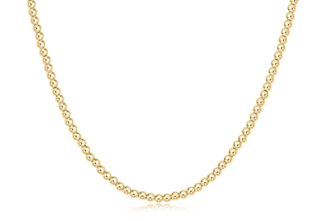 Classic gold choker necklace featuring a continuous strand of small round beads.