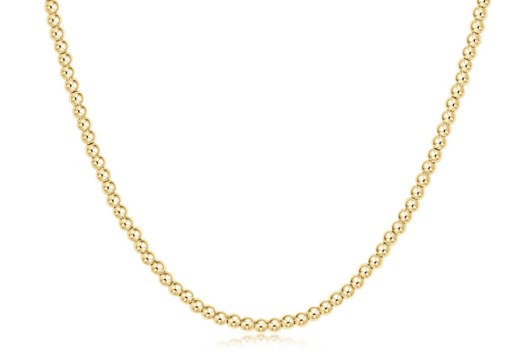 Classic gold choker necklace featuring a continuous strand of small round beads.