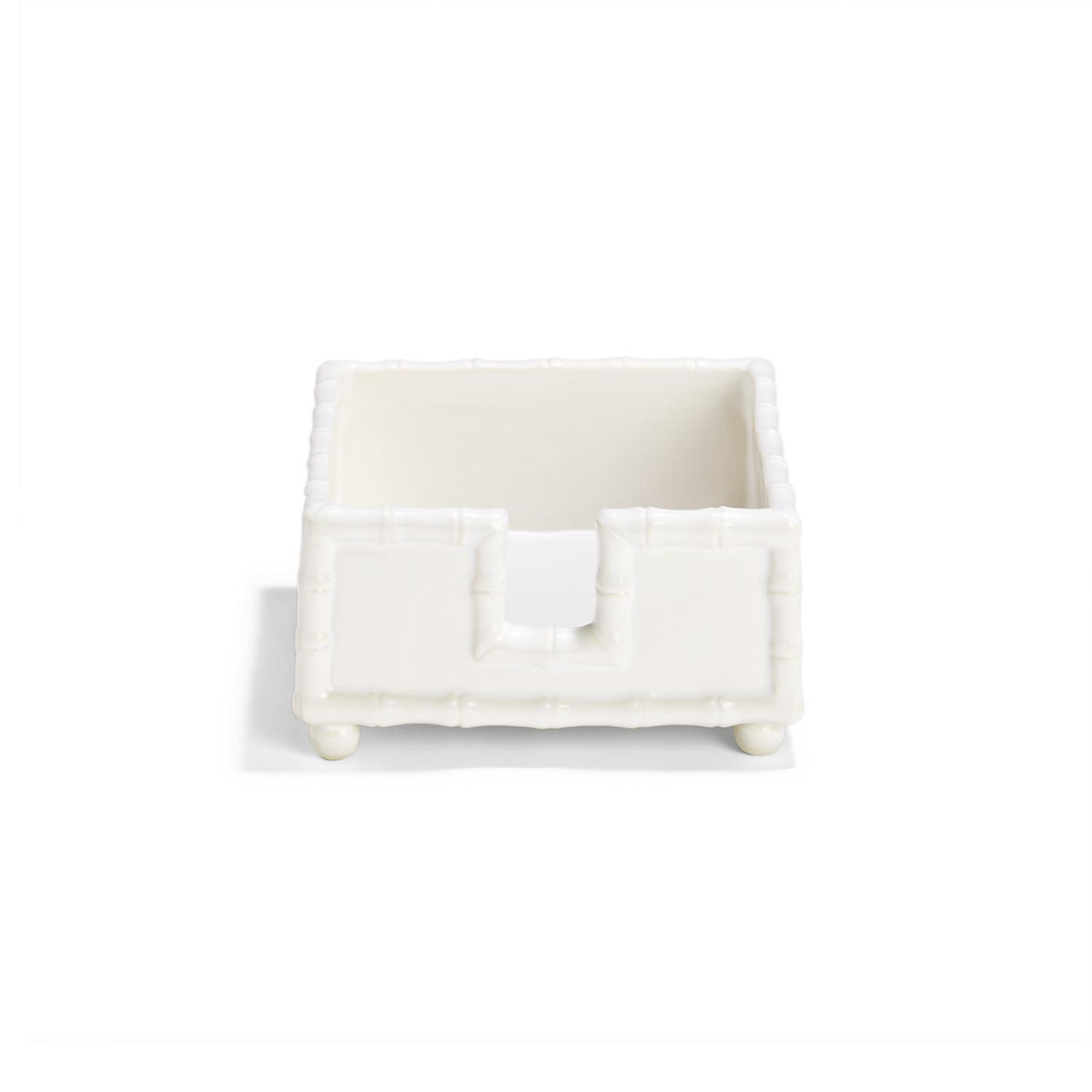 White glazed ceramic cocktail napkin holder with a faux bamboo design and four rounded feet.