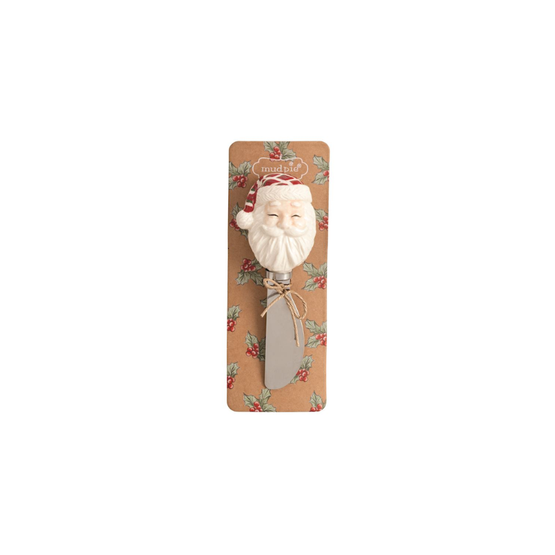 Christmas spreader with a hand-painted Santa Claus stoneware handle on a holly-patterned card.