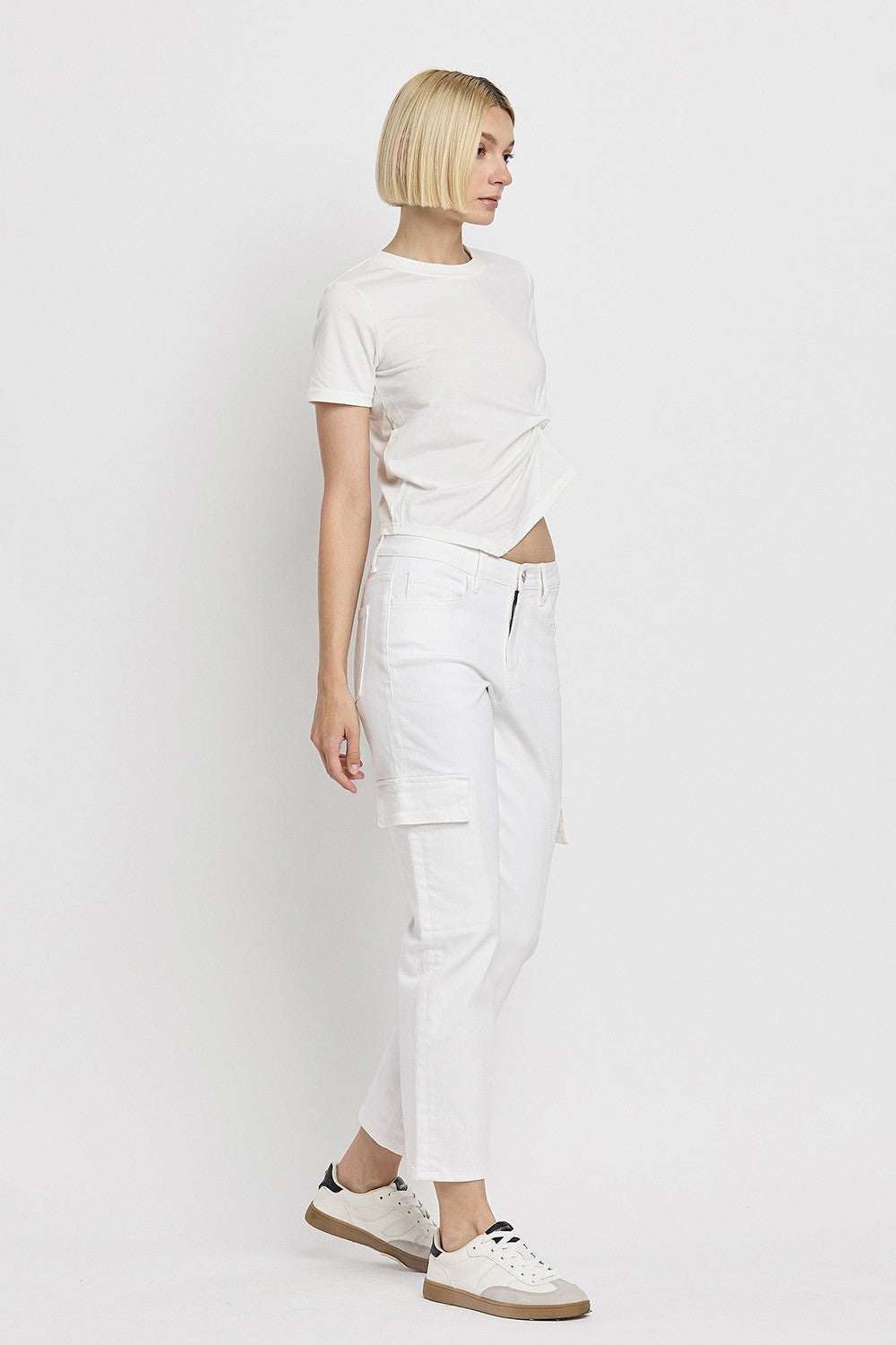 Woman wearing Megan High Rise Crop Cargo Straight Jeans in white with a white t-shirt and sneakers.