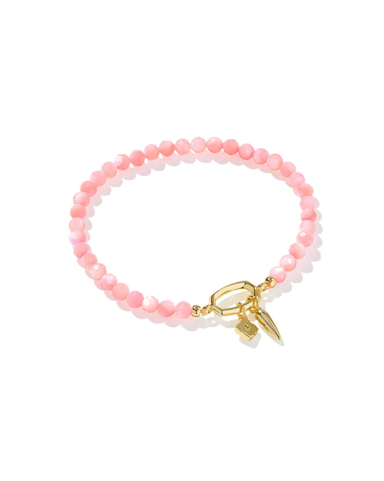 Sylvia stretch bracelet featuring pink chalcedony beads and 14k yellow gold over brass charms.