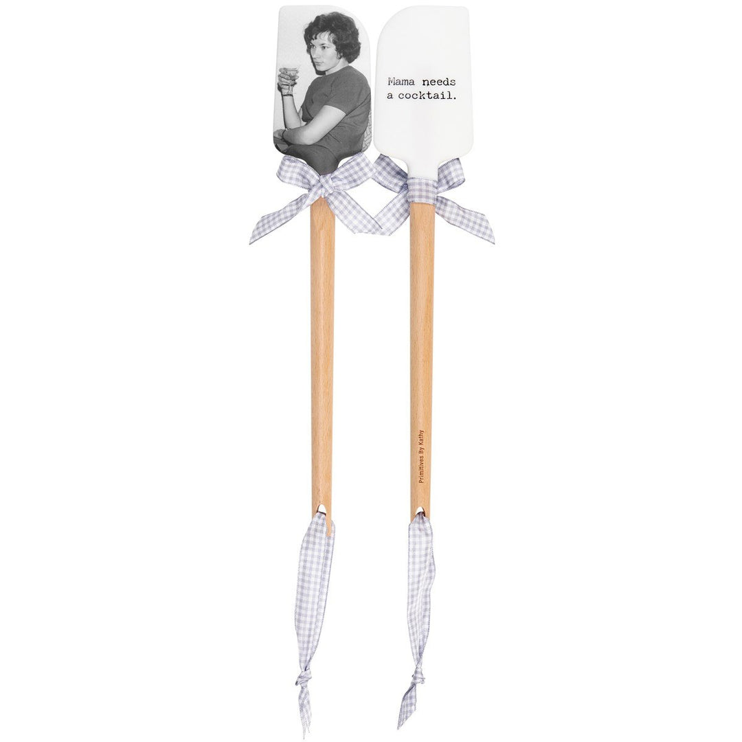 Silicone spatula with wooden handle labeled Mama Needs A Cocktail