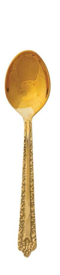 Embossed brass spoon with textured surface and rounded bowl.