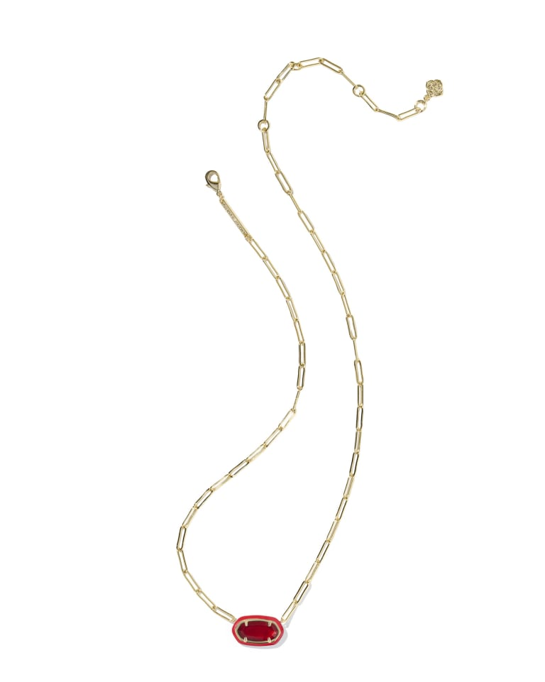 Gold paperclip chain necklace with a red stone pendant in a matching enamel frame.