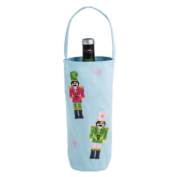 Light blue canvas wine bag with sequin nutcracker designs and a single handle.