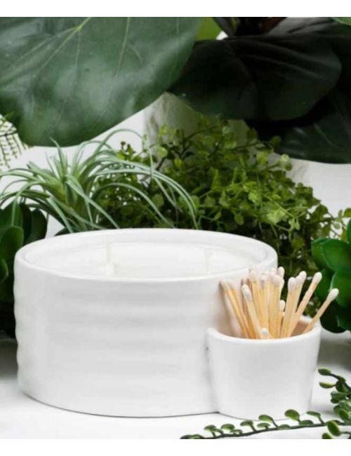 Matte white ceramic vessel candle with three wicks and a side holder for matches.