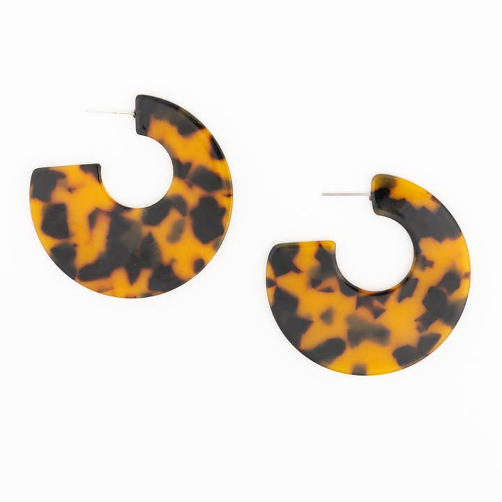 Theresa Earrings featuring a bold tortoise shell pattern in a thick, open hoop design.