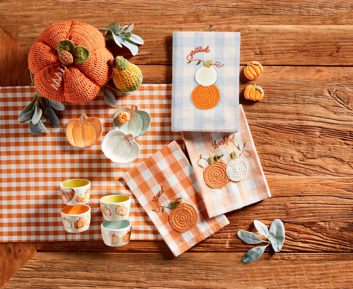 Three small pumpkin-shaped stoneware tidbit plates in orange, white, and light green.