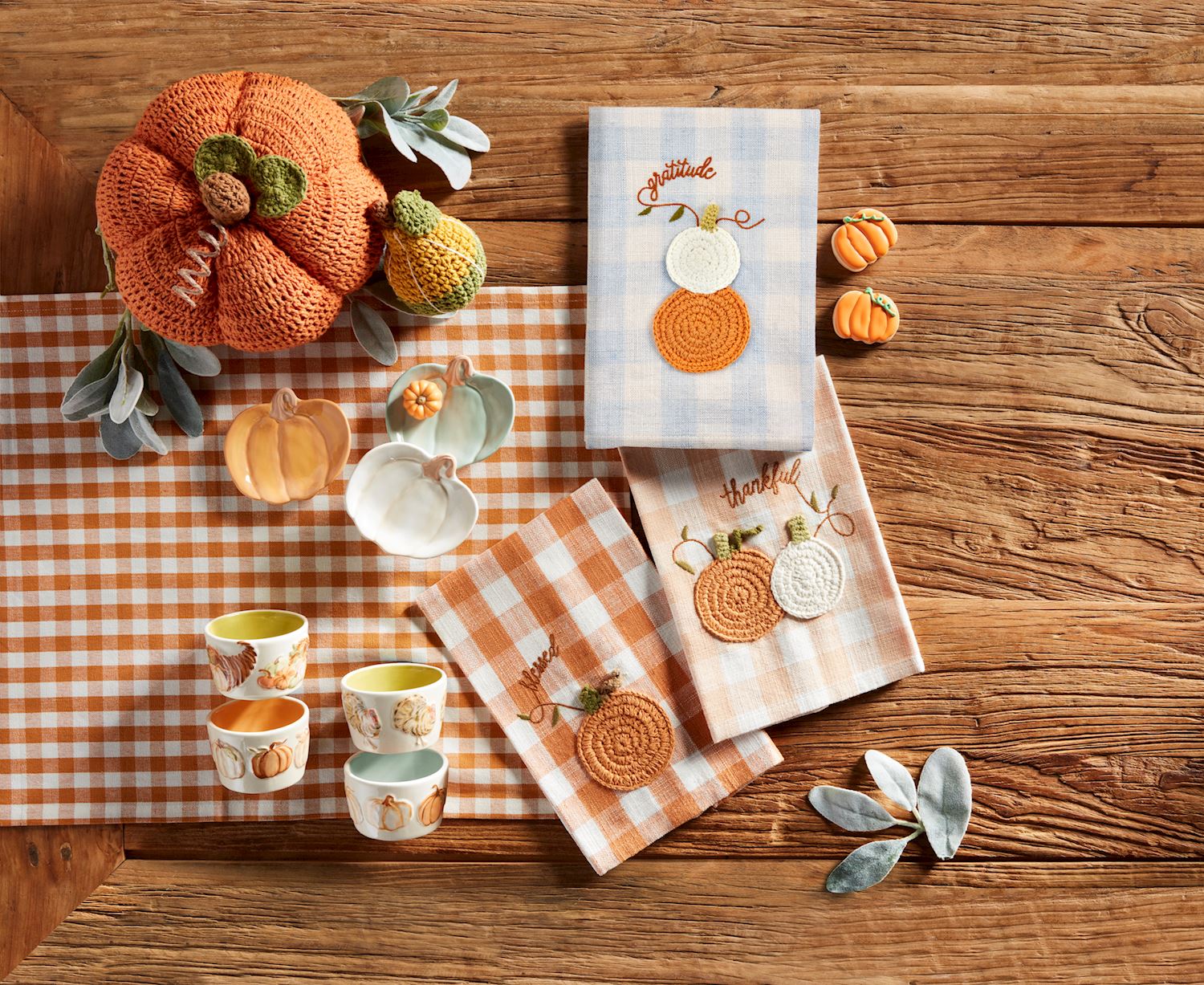 Three small pumpkin-shaped stoneware tidbit plates in orange, white, and light green.