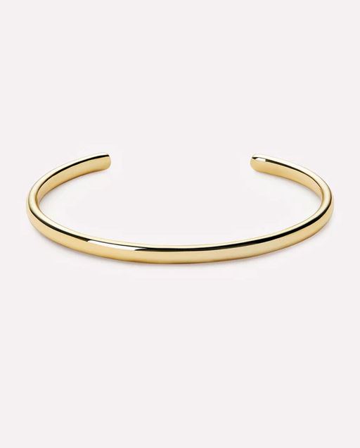 Open gold bangle bracelet with a smooth cylindrical shape.