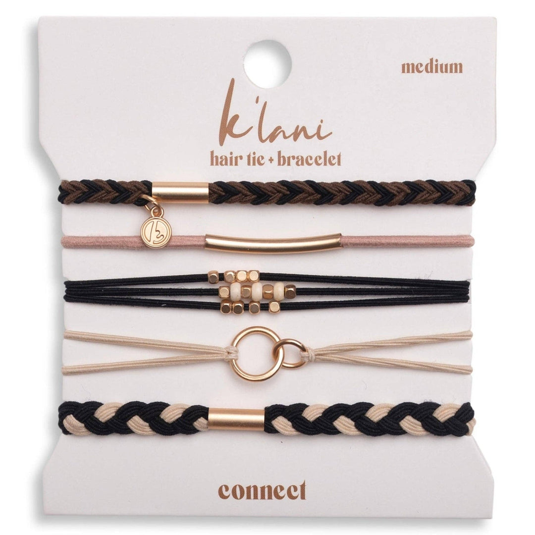 Five K'lani hair tie bracelets in black, brown, and cream with gold accents on a display card.