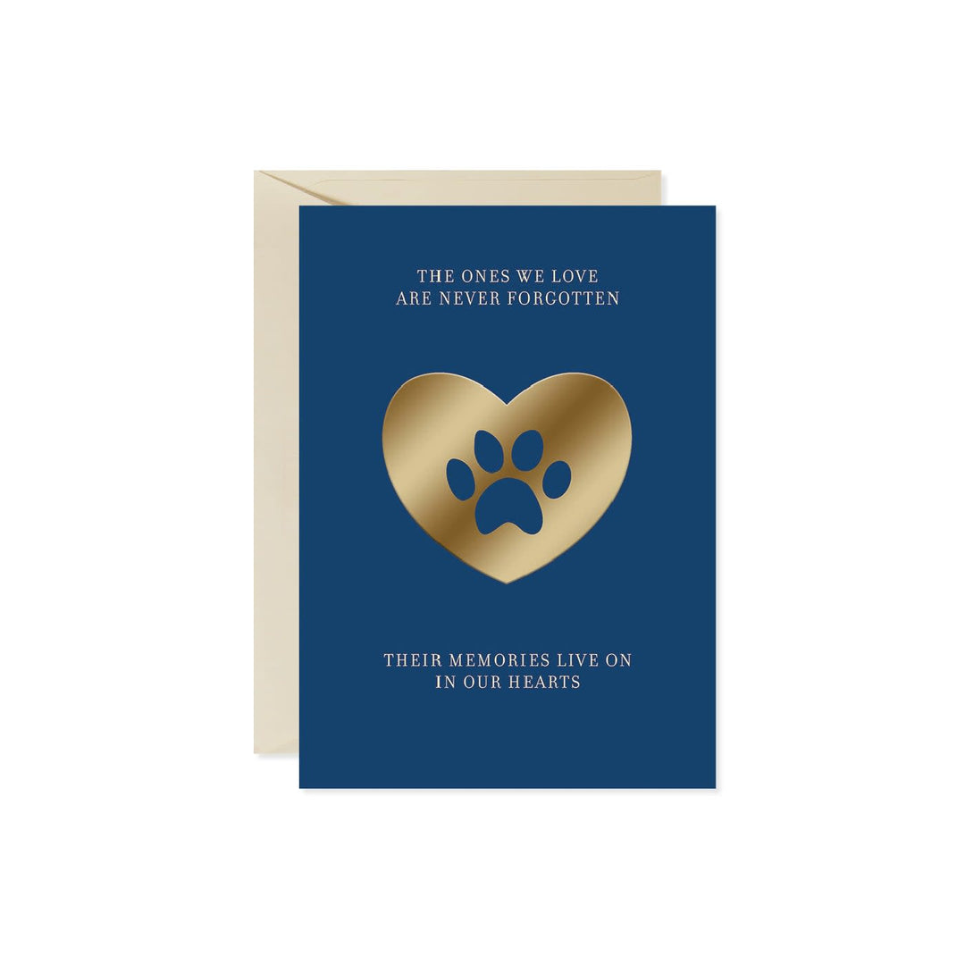 Blue sympathy card with gold heart and paw print. Text reads 'The ones we love are never forgotten. Their memories live on in our hearts.'
