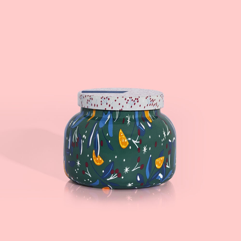 A white ceramic play signature jar with a Volcano Holiday pattern featuring festive red and green designs.