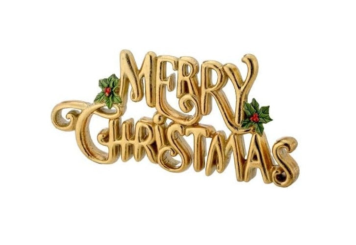 Resin table piece with Merry Christmas text in gold lettering on a dark background.