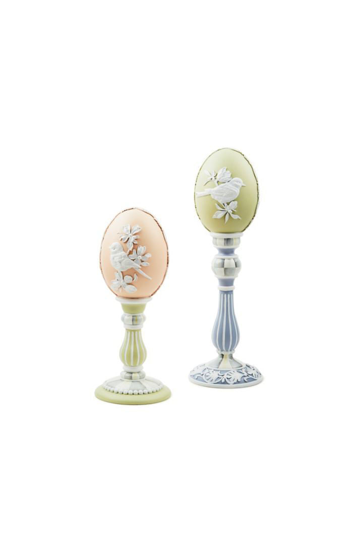 Cameo Pedestal Eggs: three white ceramic eggs with gold pedestal bases.