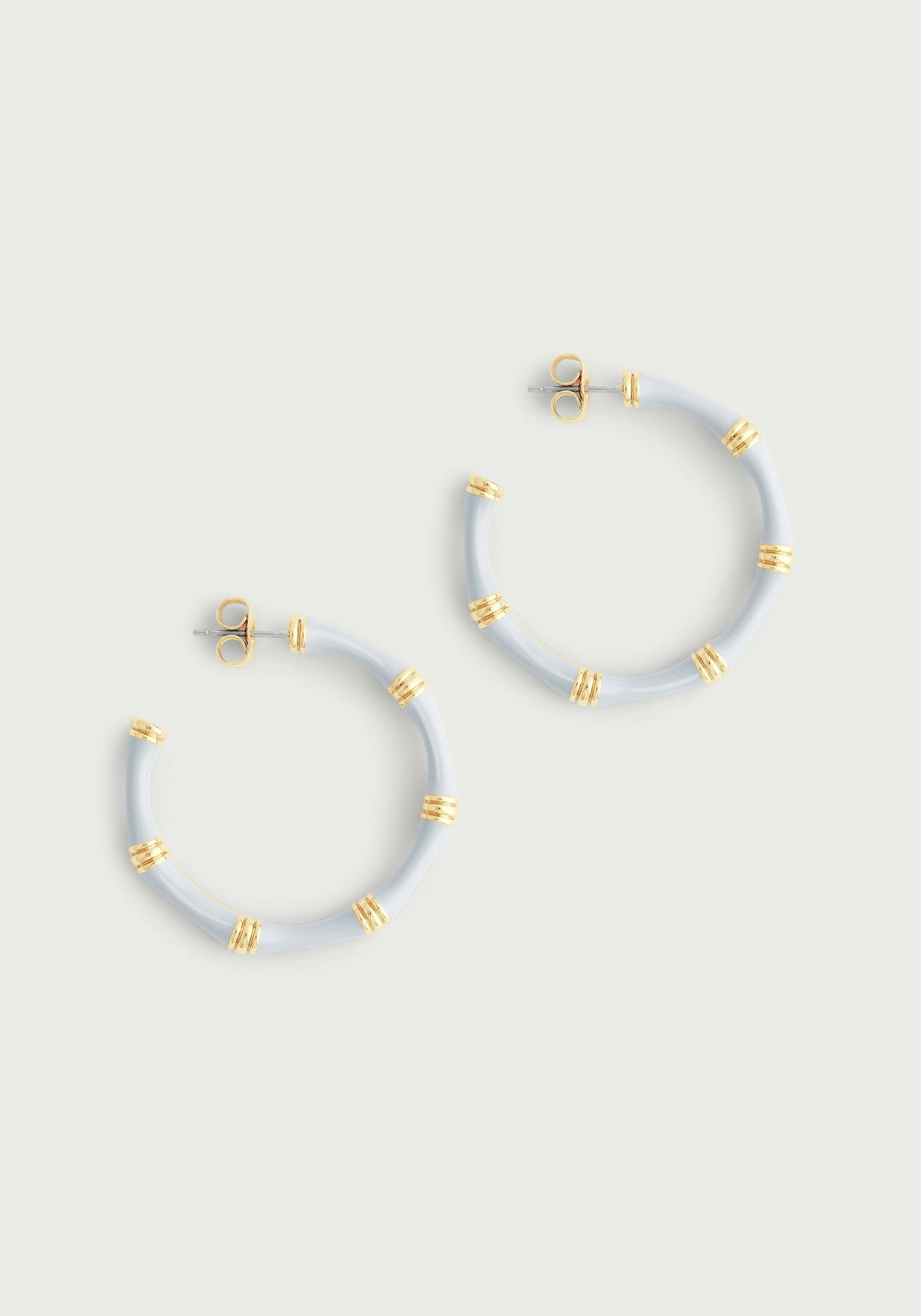 Light blue bamboo-style enameled hoop earrings with 18K gold-plated brass accents.