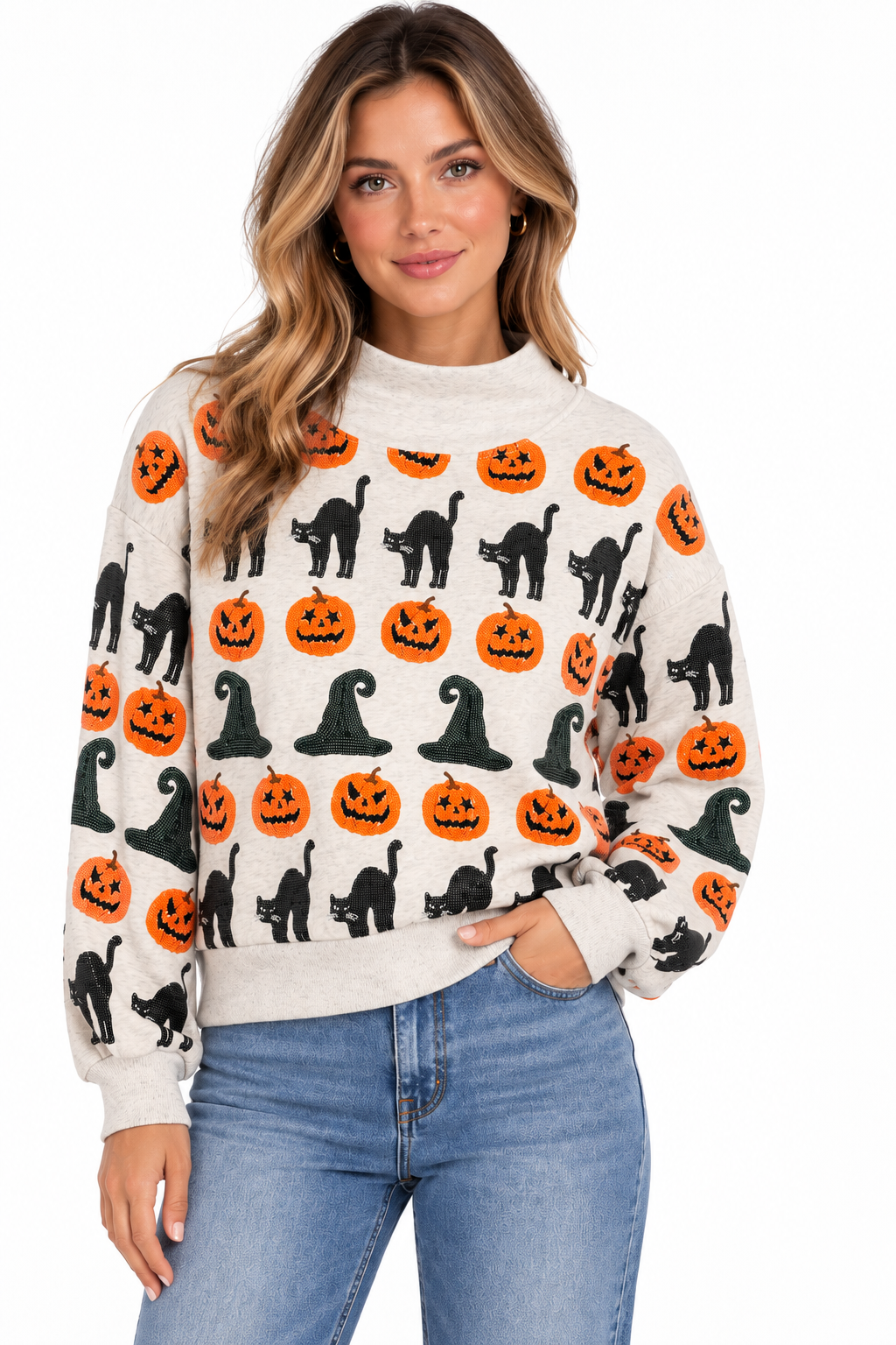 Woman wearing a Hannah mockneck sweatshirt with witch hat, pumpkin, and black cat sequin patterns.