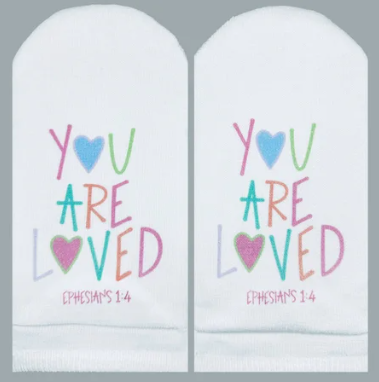 White socks with colorful text reading "YOU ARE LOVED" and "EPHESIANS 1:4" with heart graphics.