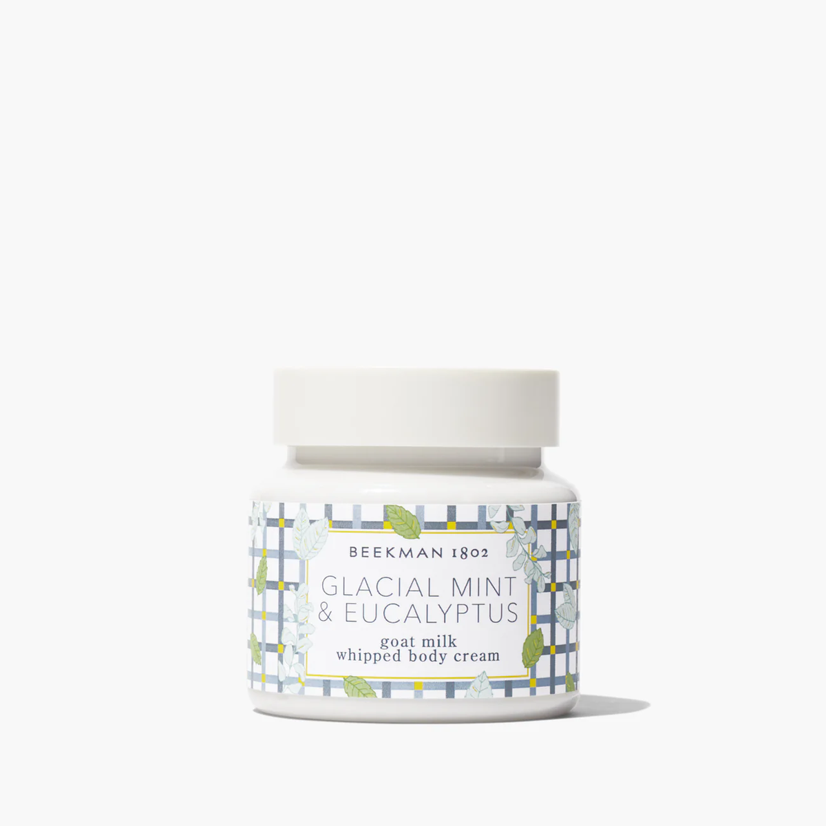 Beekman 1802 Glacial Mint & Eucalyptus goat milk whipped body cream in a white jar with plaid label.