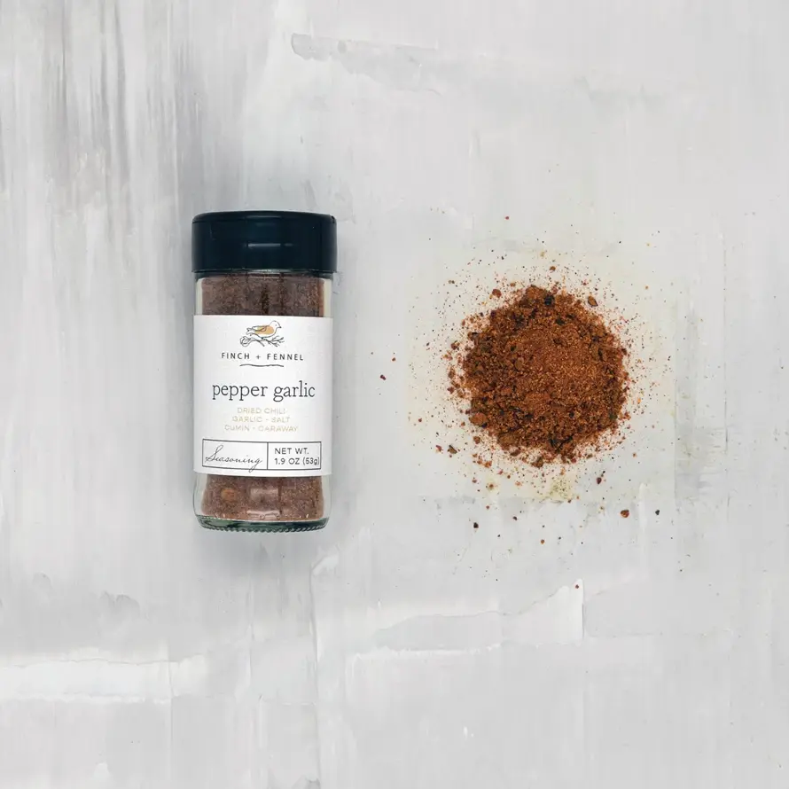 Pepper Garlic Blend spice jar with a white label on a neutral background.