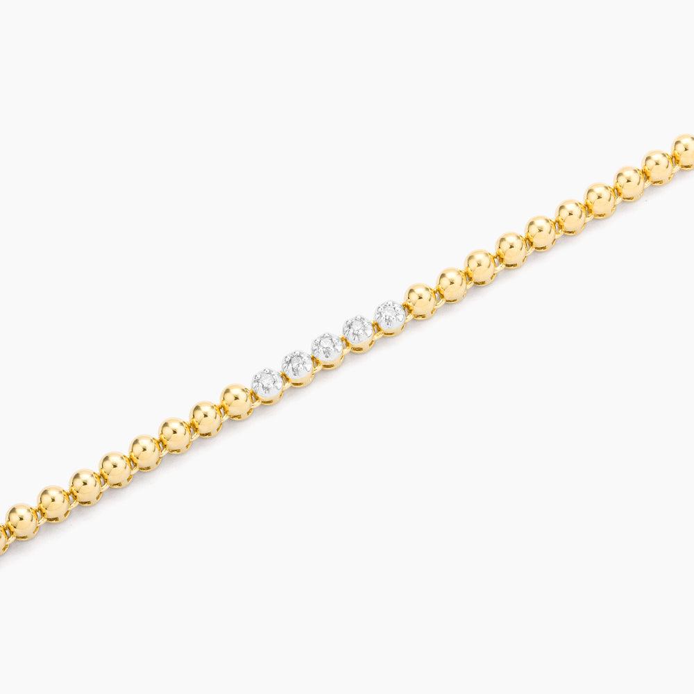 Close-up of the Aza Chain Bracelet featuring gold beads and a center row of small diamonds.