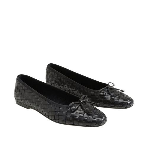 A pair of black woven leather square-toe ballet flats with decorative bows on the front.