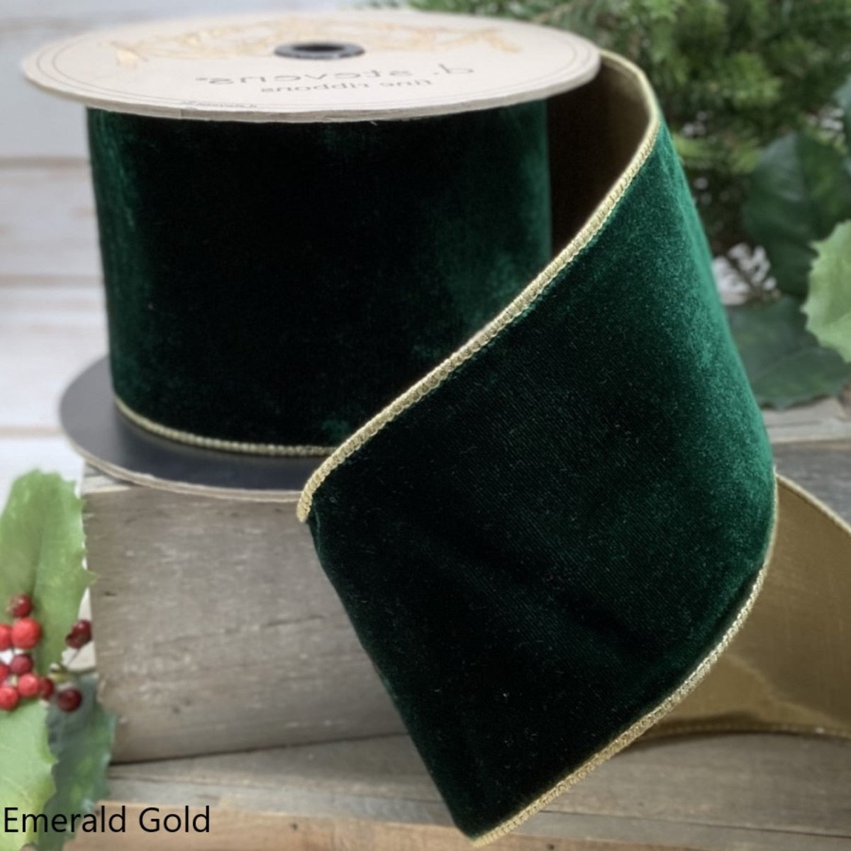 4 inch wide emerald green velvet ribbon with gold wired edges on a spool.