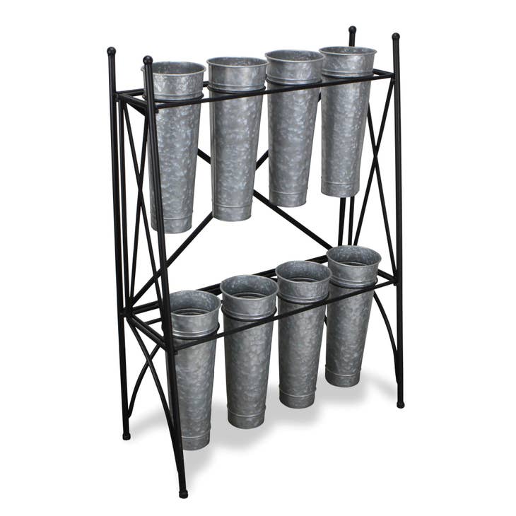 Metal plant stand with eight galvanized steel tapered pots arranged in two rows.