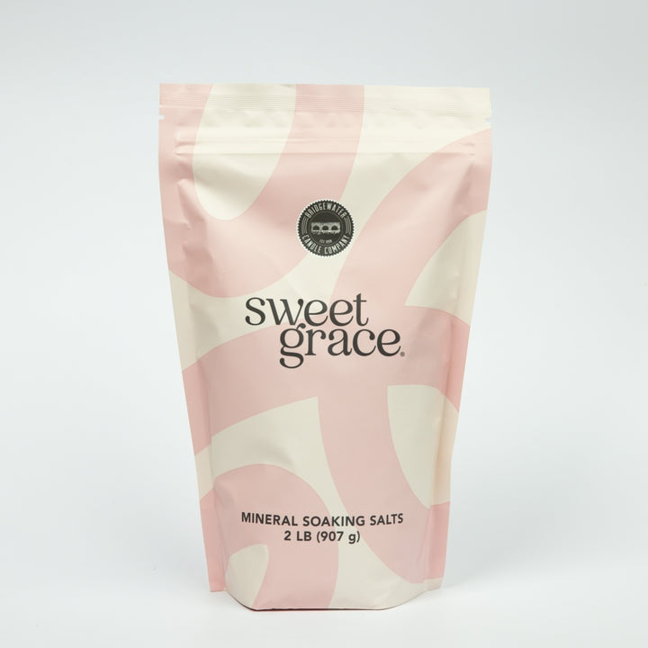 A bag of Sweet Grace soaking salts featuring pink Hawaiian sea salt blend.