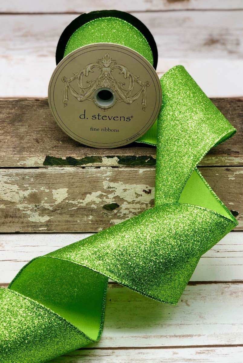 4 inch wide apple green vintage glitter ribbon by d. stevens on a wooden surface.